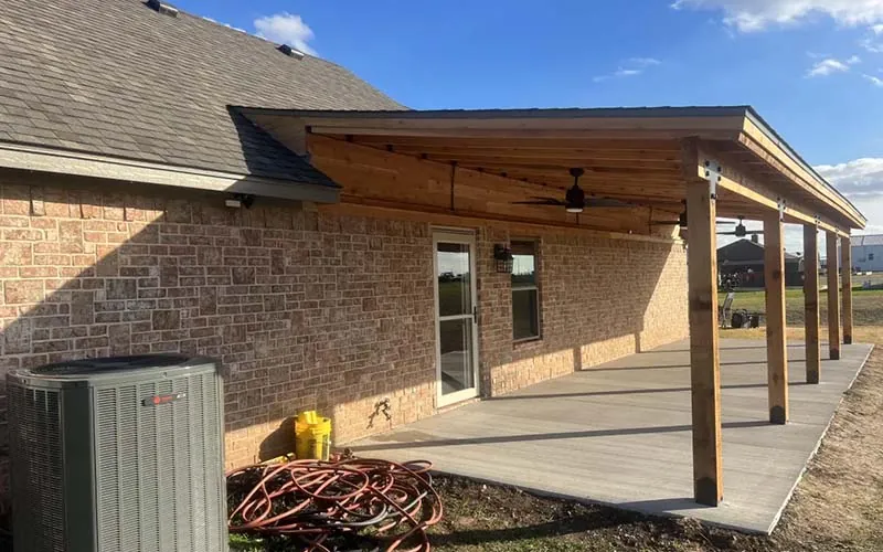 Covered patio with a cedar ceiling and ceiling fans