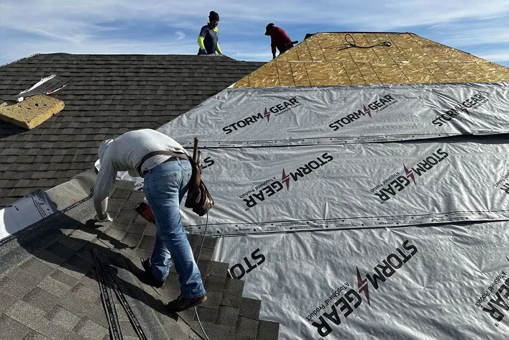 Legacy crew repairing a roof section over new underlayment